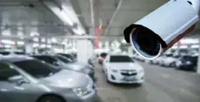 AI camera watching an open parking lot entrance.