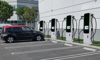 Property owner reviewing an EV charging vendor contract on a desk.