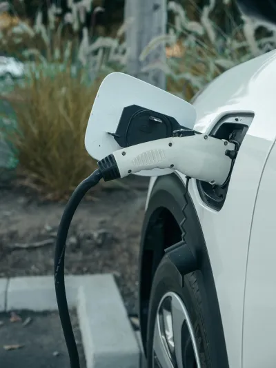 Electric vehicle charging station in a paid parking lot.
