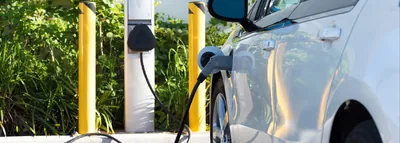 Level 2 EV charging stations installed in a commercial property parking lot.
