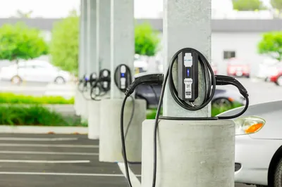 Electric vehicle charging station at a commercial property evaluating revenue share and ownership models.