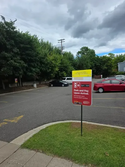 Driver scanning a QR code to pay for parking with their smartphone.
